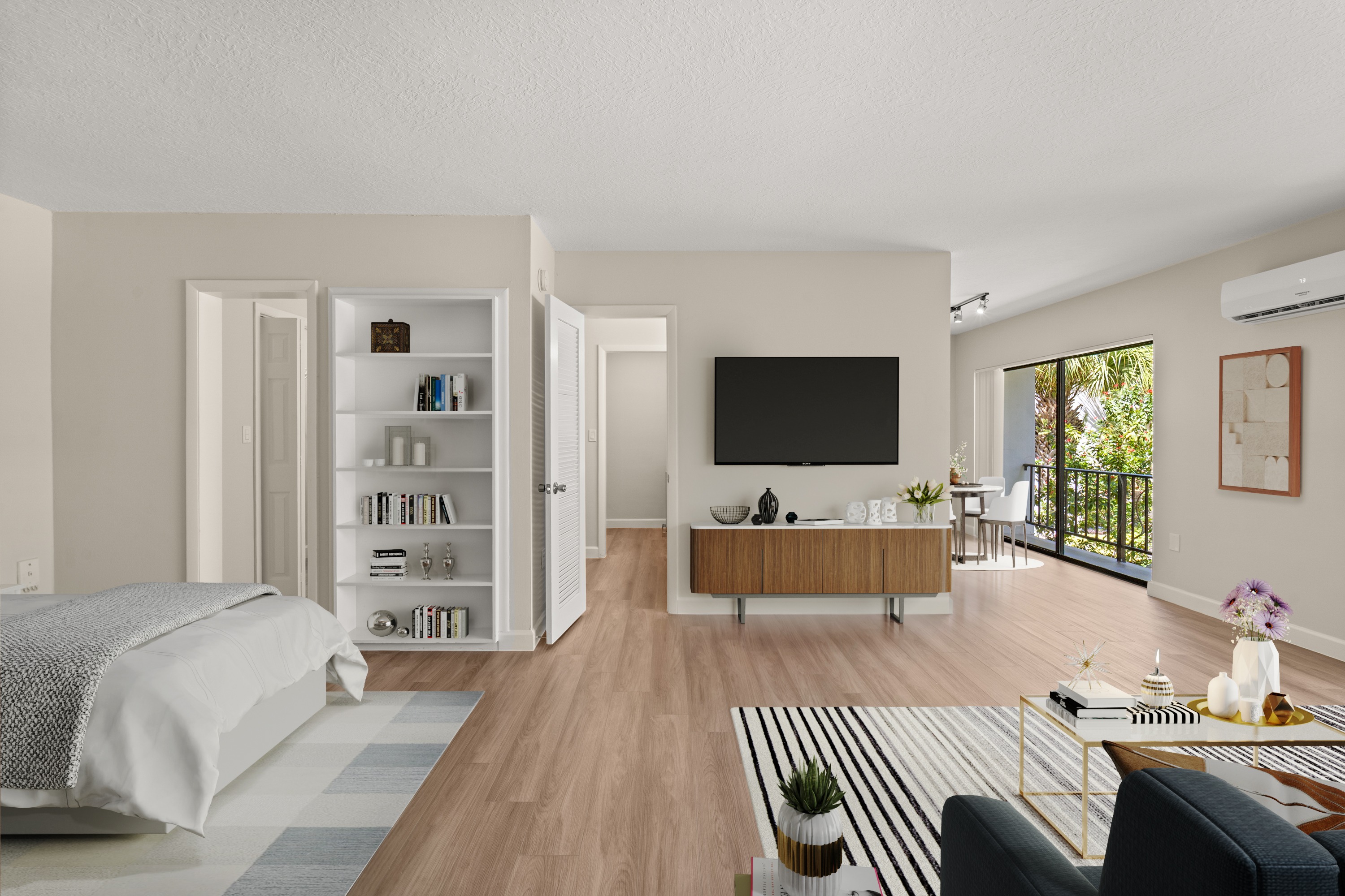 A modern living room with a white bed and a television.